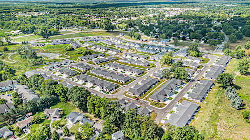 A bird's eye view of a residential area with houses and trees.