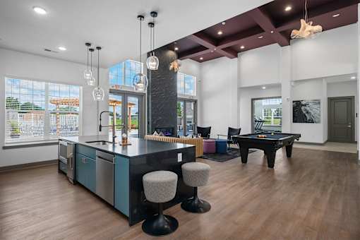 A kitchen with a bar area and a dining table.