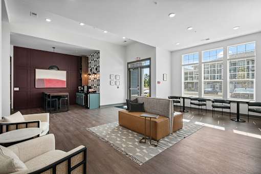 A modern living room with a brown sofa and a grey coffee table.