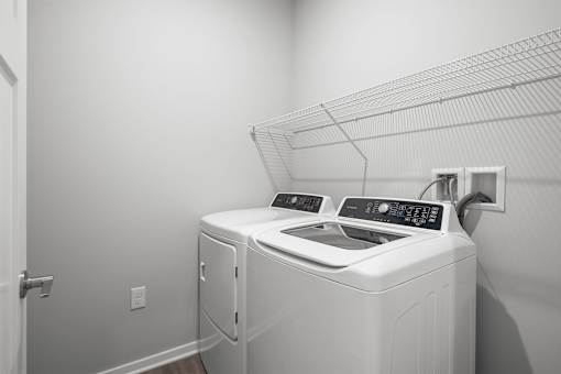 A white washing machine and dryer in a laundry room.