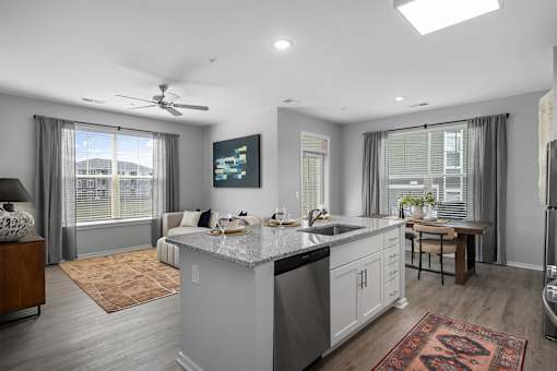 A modern kitchen with a large island and a dining area.
