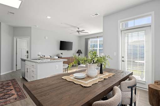A modern dining room with a wooden table and chairs.
