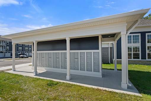 A modern building with a white roof and grey columns.