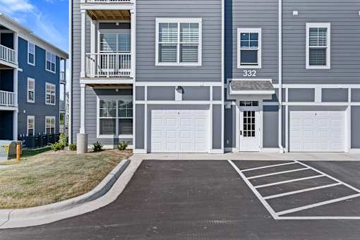 Apartment building with garage doors and number 332 on the front.