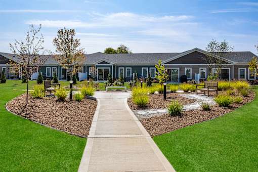 A building with a green lawn in front of it.