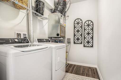 A white washing machine and dryer in a small laundry room.