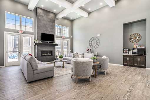 A modern living room with a fireplace and a television.