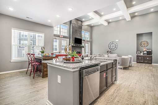 A kitchen with a large island and stainless steel appliances.
