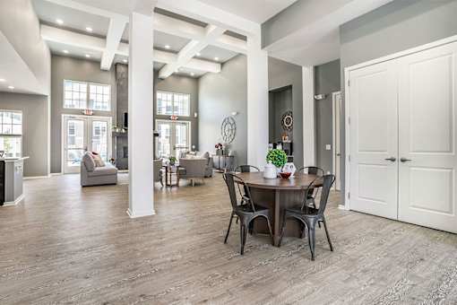 A dining room with a table set for two.