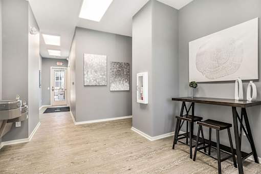 A room with a wooden floor and a large painting on the wall.