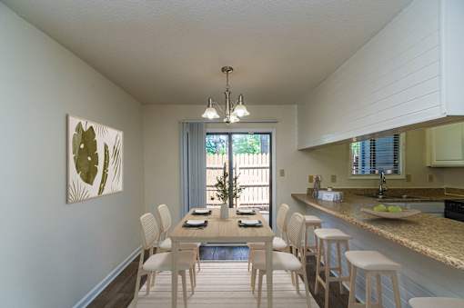 A dining room with a table set for four.