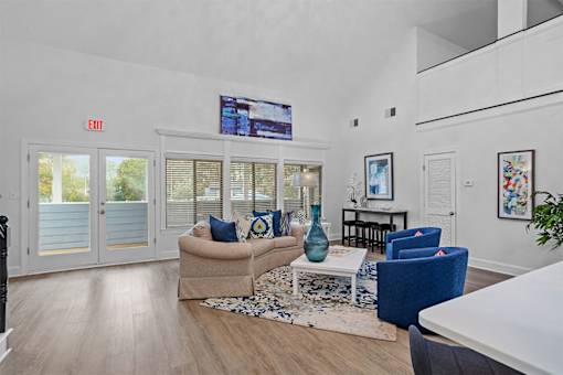 A living room with a couch, chairs, and a coffee table.