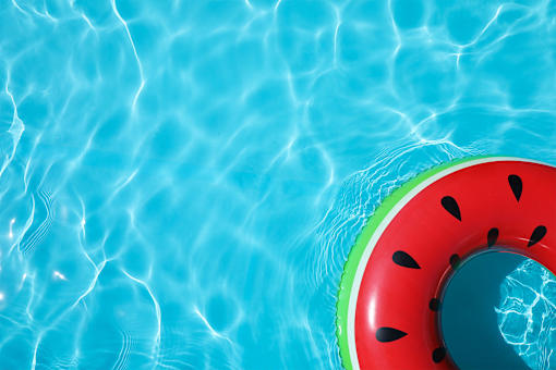 A watermelon-shaped float in a pool of water.
