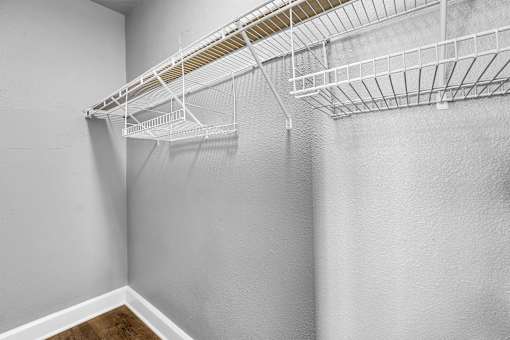 Empty white shelves on a wall.