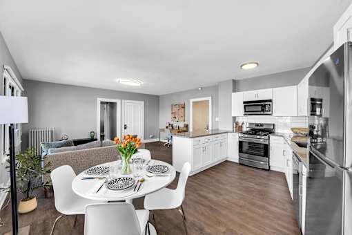 A modern kitchen with a dining table set for four.