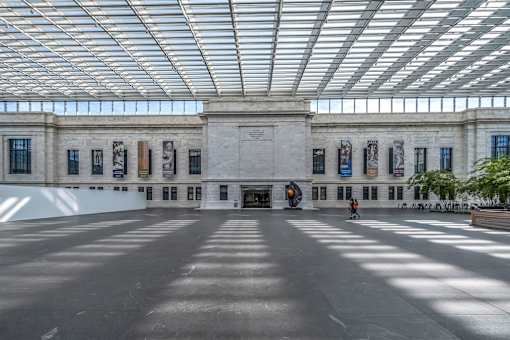 A large open space with a person walking in the middle.