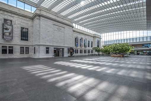 The interior of a museum with a glass roof and walls.