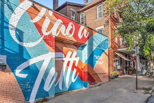 A wall with a mural that says "Hello" in white letters.