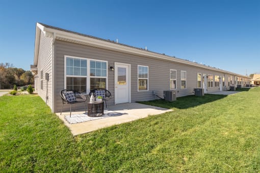 the exterior of a home with a patio and a yard