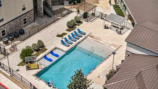 A pool with a slide and a hot tub.