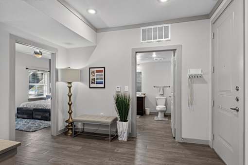 A bathroom with a toilet, sink, and a mirror.