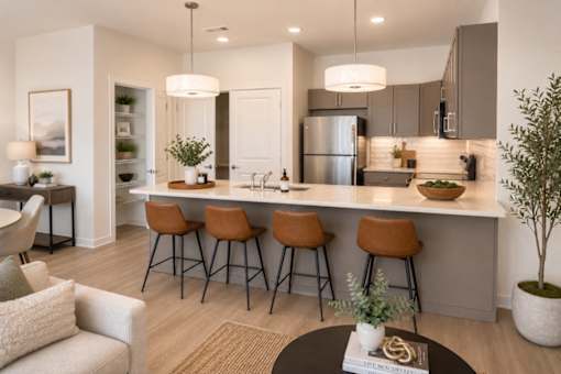 A modern kitchen with a bar area and seating.