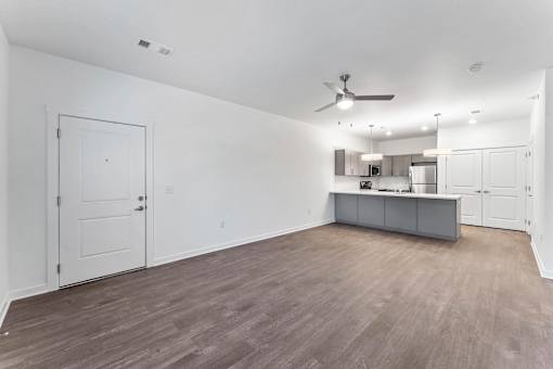 A room with a ceiling fan and a cabinet.