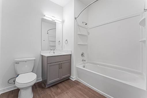 A white toilet is next to a sink in a small bathroom.