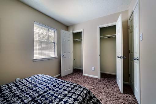 A bedroom with a bed and a window.