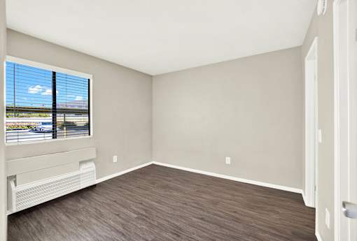 A room with a window overlooking a highway.