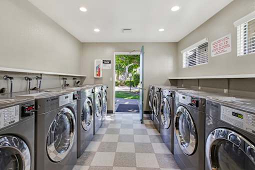 A row of washing machines in a laundromat.
