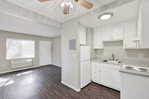 A kitchen with white appliances and cabinets.