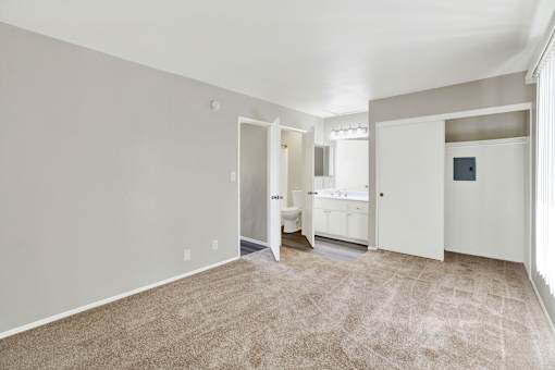 A room with a carpeted floor and white walls.