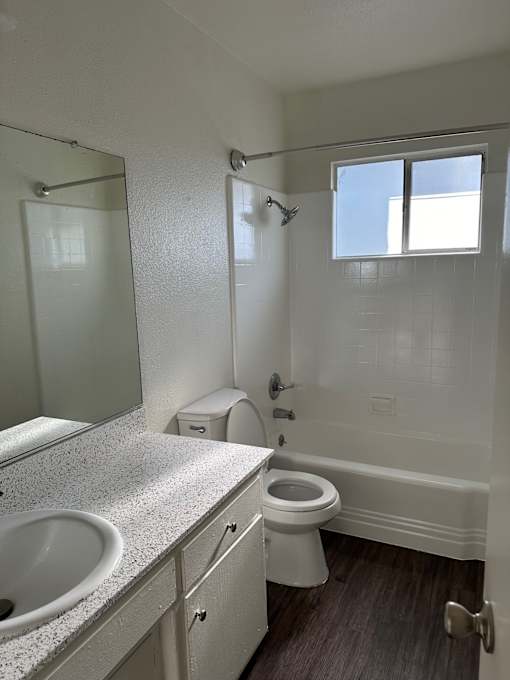 an empty bathroom with a toilet and a sink