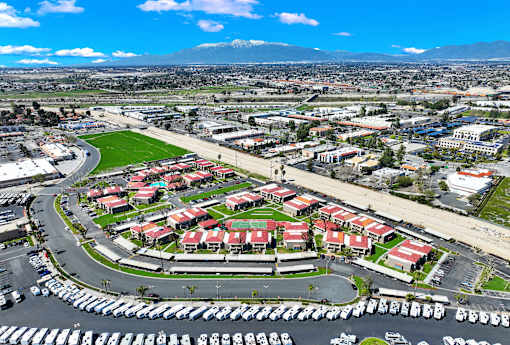A large parking lot is in the foreground of a cityscape.