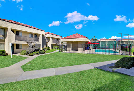 A sunny day at the apartment complex with a clear blue sky.