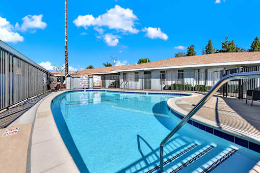 A swimming pool with a metal fence around it.