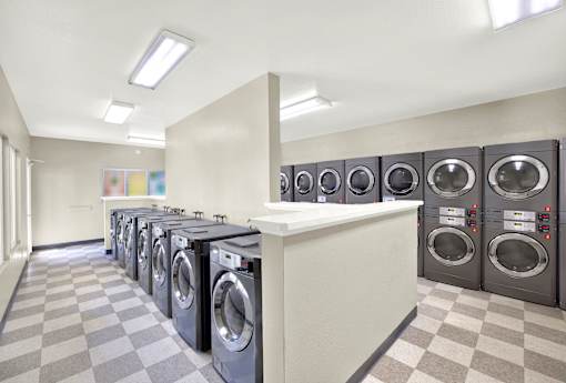 A row of washing machines in a laundromat.