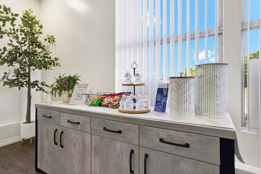 Refreshment station with bottled water and snacks at ELEVATE Apartments HOMES, Placentia, California