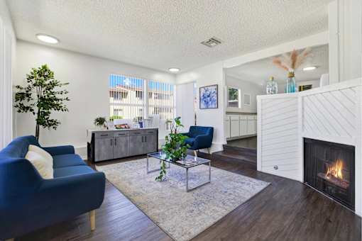 Modern living room with fireplace and seating at ELEVATE Apartments HOMES, Placentia
