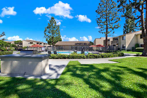 Outdoor pool area with landscaping and sundeck at ELEVATE Apartments HOMES, California