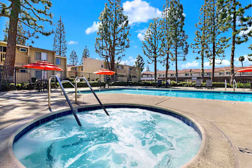 Hot tub and pool with surrounding seating at ELEVATE Apartments HOMES, Placentia, CA 92870