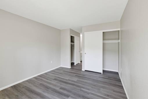A room with a grey floor and white walls at THE STREAMS Apartments, Apartments, Fullerton, CA