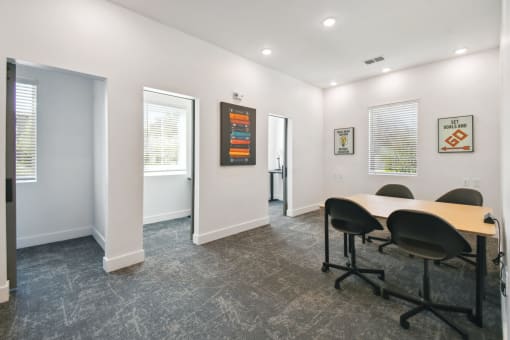 a conference room with a table and chairs in front of a window at Gibson Oaks, Lakeland, 33809
