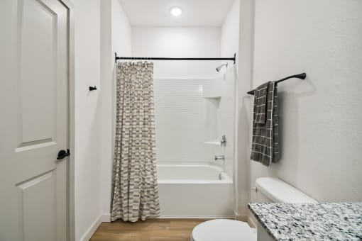 a bathroom with a shower and a toilet and a shower curtain at Gibson Oaks, Lakeland, 33809