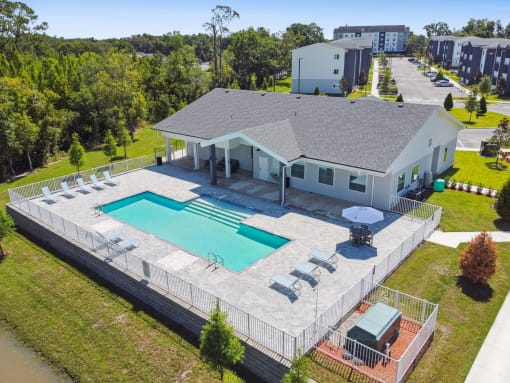 an aerial view of a house with a swimming pool and patio furniture at Gibson Oaks, Lakeland, 33809
