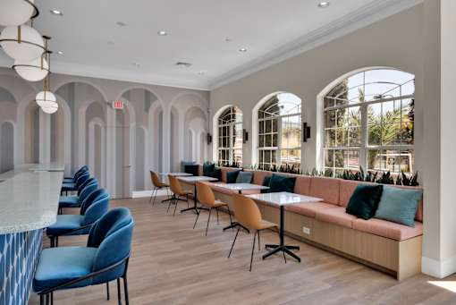 Clubhouse with a long couch and tables and chairs