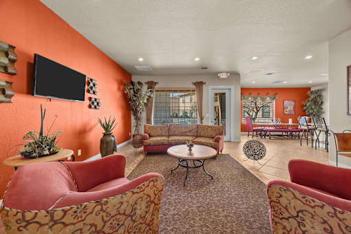 A living room with orange walls and furniture.
