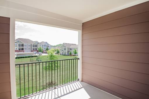A balcony with a view of a residential area.