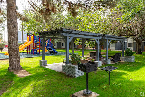 A playground with a slide and a gazebo.